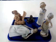 A tray containing three Nao figures together with an Italian Pottery figure, boy with book,