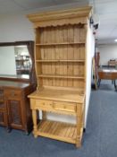 A stripped pine Welsh dresser fitted two drawers with under shelf