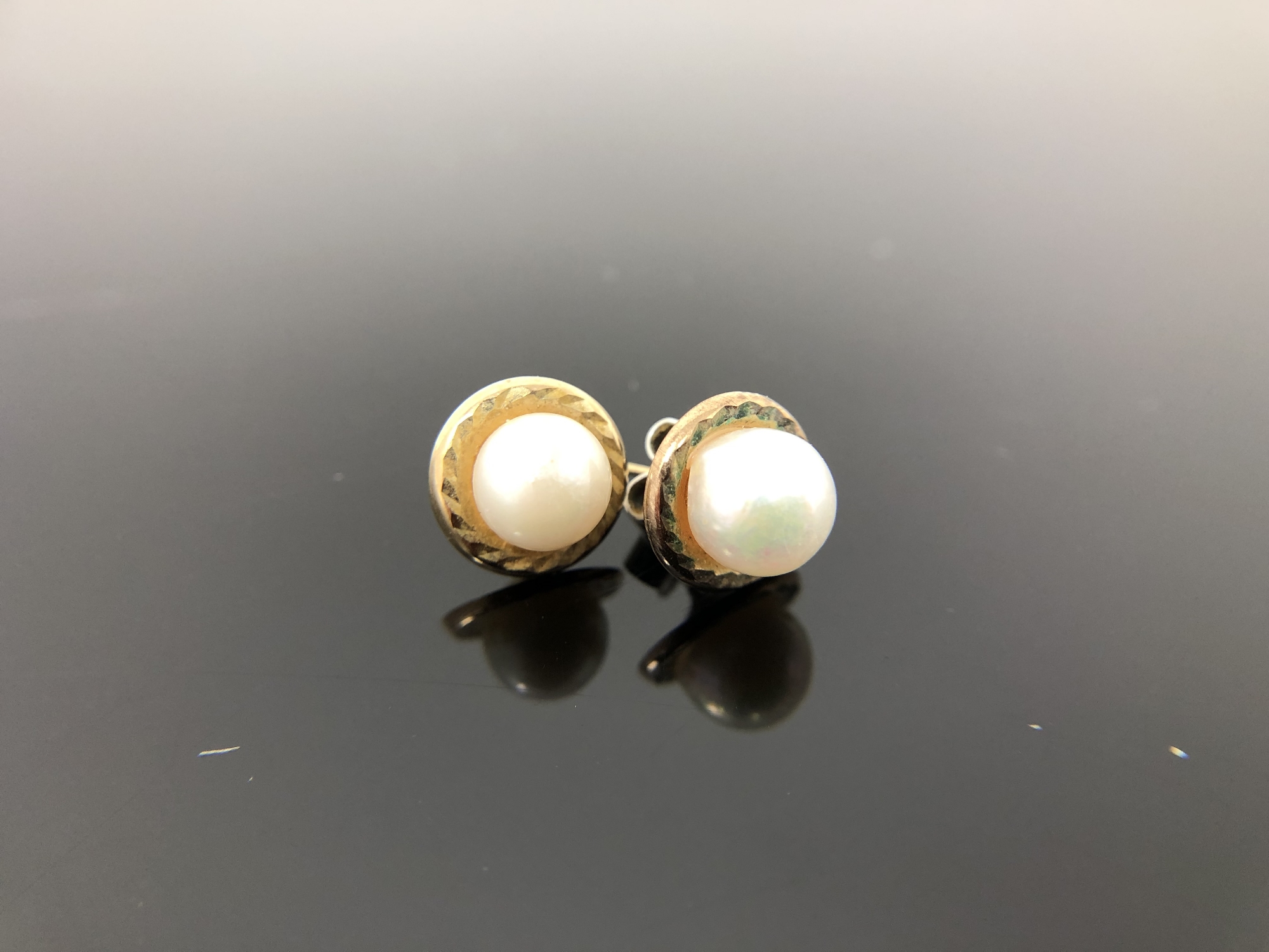 A pair of 9ct gold mounted pearl earrings.