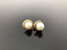 A pair of 9ct gold mounted pearl earrings.