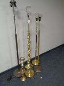 Five continental brass standard lamps together with a table lamp