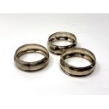 A set of three silver napkin rings.