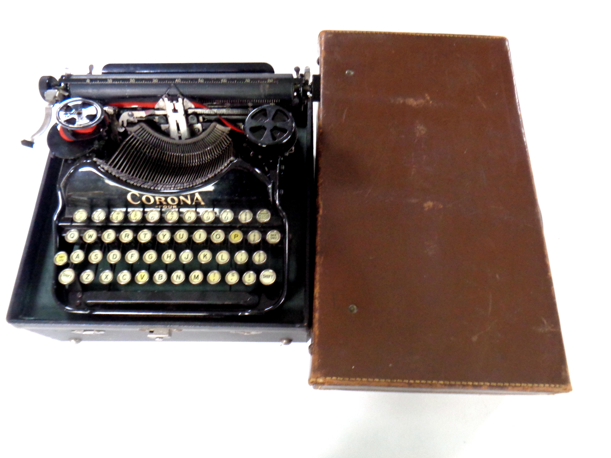 A cased vintage Corona typewriter together with a vintage leather luggage case