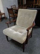 A 20th century beech framed armchair in an antique finish