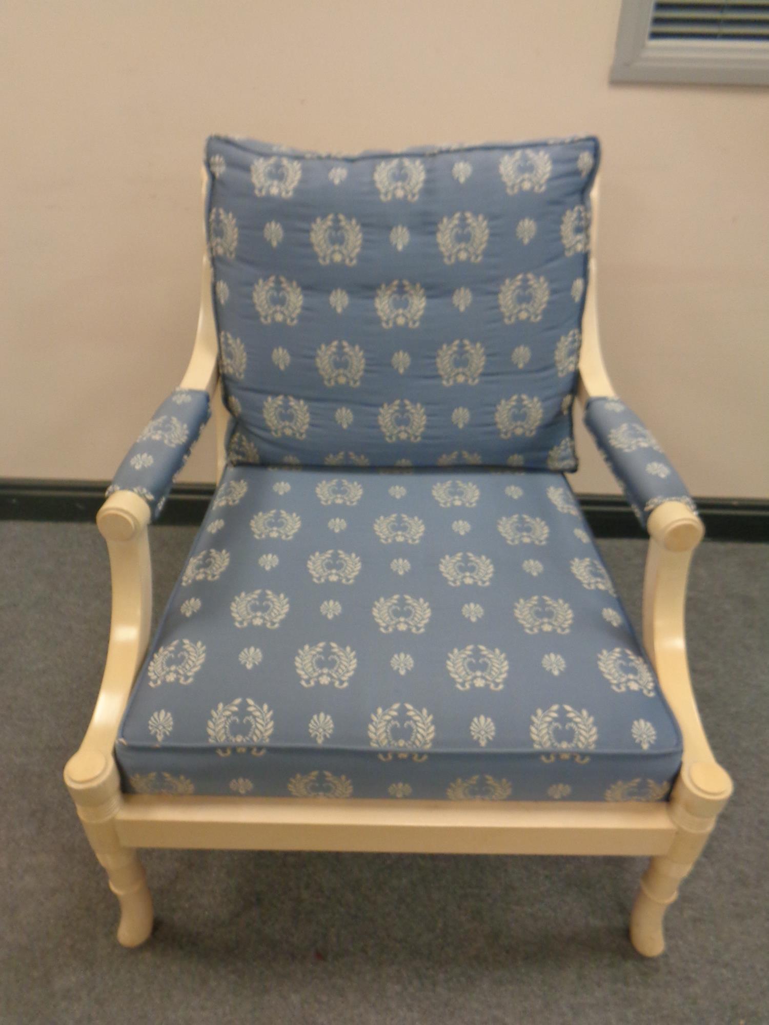 A wood framed armchair upholstered in a classical blue and gold fabric