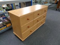 A pine effect eight drawer chest