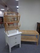 A contemporary pine two tier bedside table together with a bamboo and wicker magazine rack,
