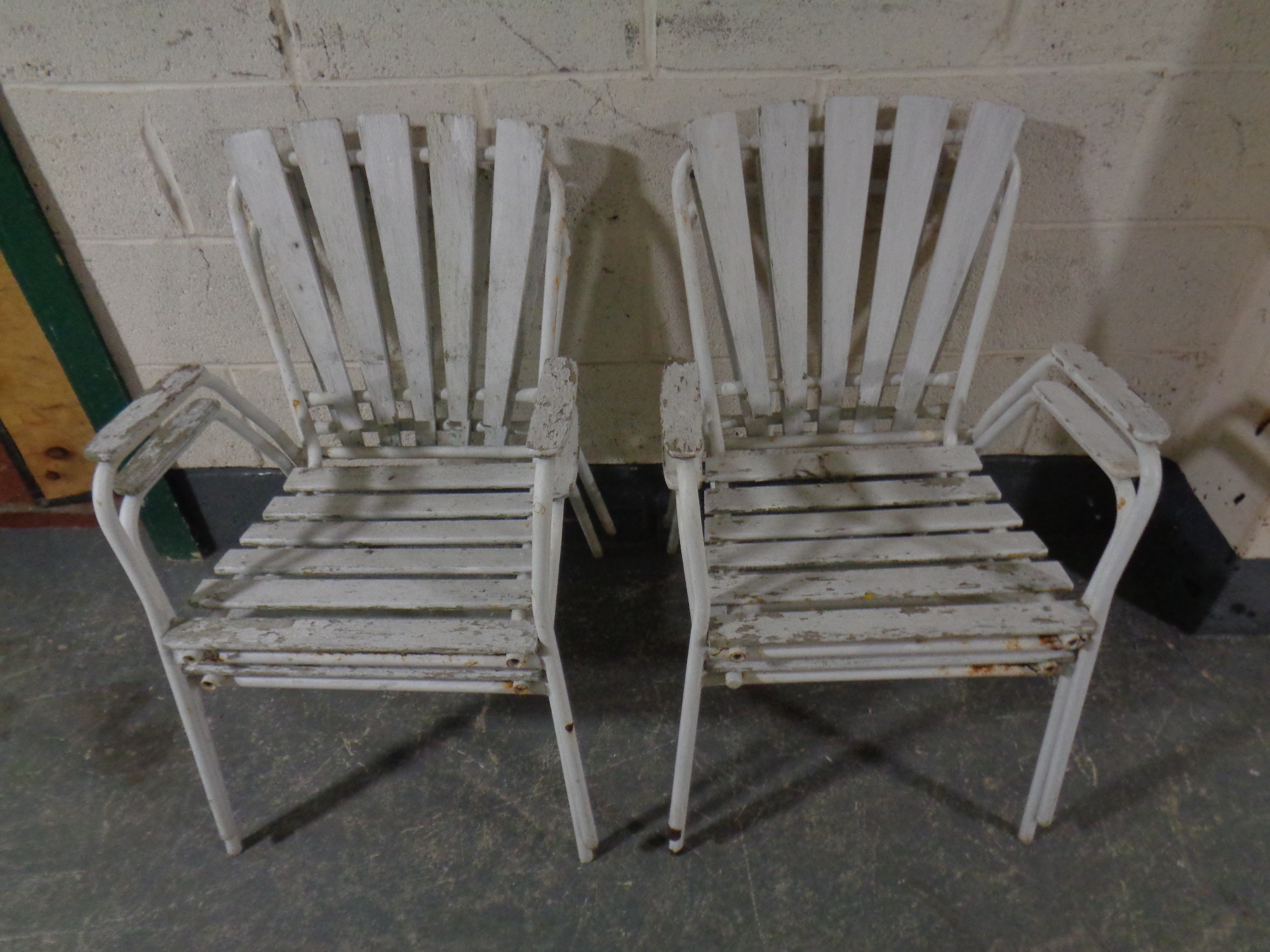 A set of four 20th century painted tubular metal and wooden garden armchairs