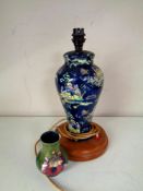 A blue glazed pottery Oriental style table lamp on wooden base together with a Moorcroft vase (A/f)