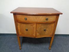 A Regency style inlaid mahogany double door cabinet fitted a drawer on raised legs