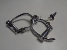 A pair of horse shoe hand cuffs with key