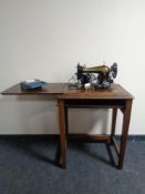 A 20th century Singer electric sewing machine in oak table