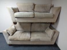 A contemporary three seater settee with matching two seater settee upholstered in a beige fabric