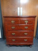 An Edwardian stained pine five drawer chest
