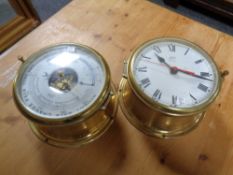 A brass ship's style wall clock and barometer