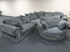 A large corner suite with matching cuddle chair upholstered in a two tone fabric together with a