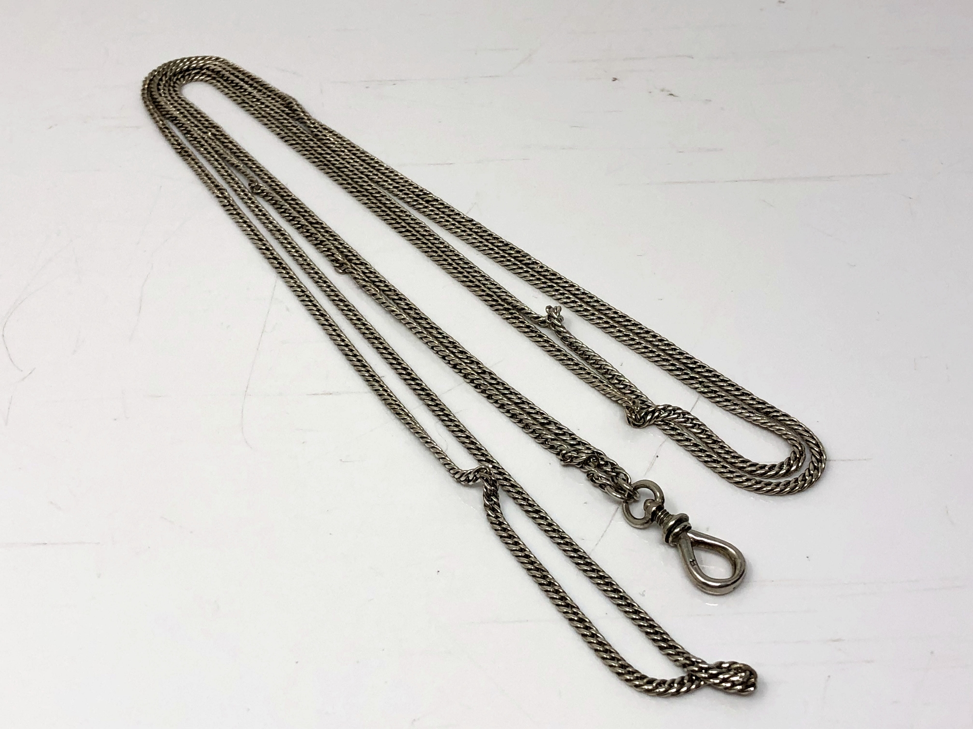 A long antique silver guard chain