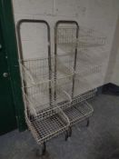 A pair of metal stands with seven wire metal baskets