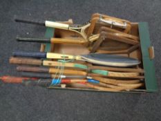 A box of vintage badminton and tennis rackets,