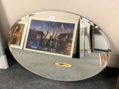 An oval frameless mirror,