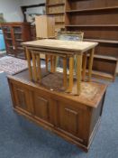 A nest of three 20th century teak tables together with a blanket box
