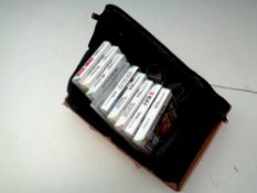 A box of Nintendo DS with charger and games, carry bag.