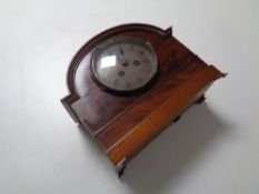 An Edwardian mahogany mantel clock with silvered dial on raised feet by Sorley of Glasgow