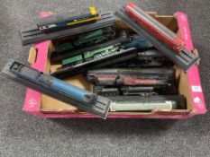 A box containing fifteen die cast model trains on stands to include Flying Scotsman, A4 Mallard,