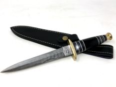 A commando style knife with Damascus steel blade,