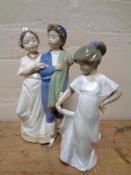 A Nao figure, boy and girl in traditional Spanish dress, together with a further Nao figure,