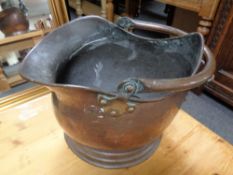 An antique copper swing handled coal bucket