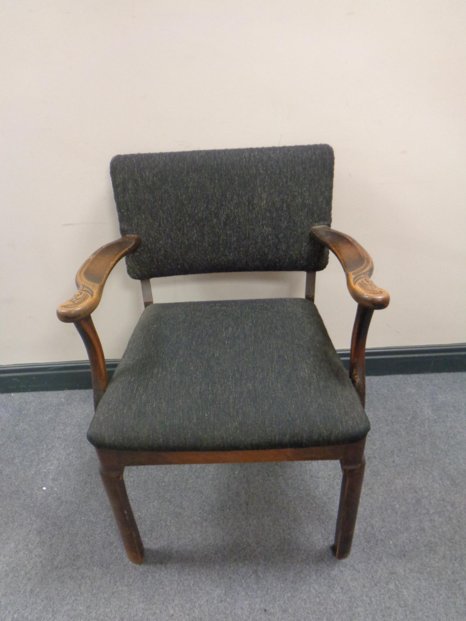 A 20th century carved beech armchair upholstered in a black fabric