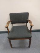 A 20th century carved beech armchair upholstered in a black fabric