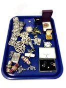 A tray containing costume jewellery, EPNS belt and nurses buckles, cigar cutter, vesta case,