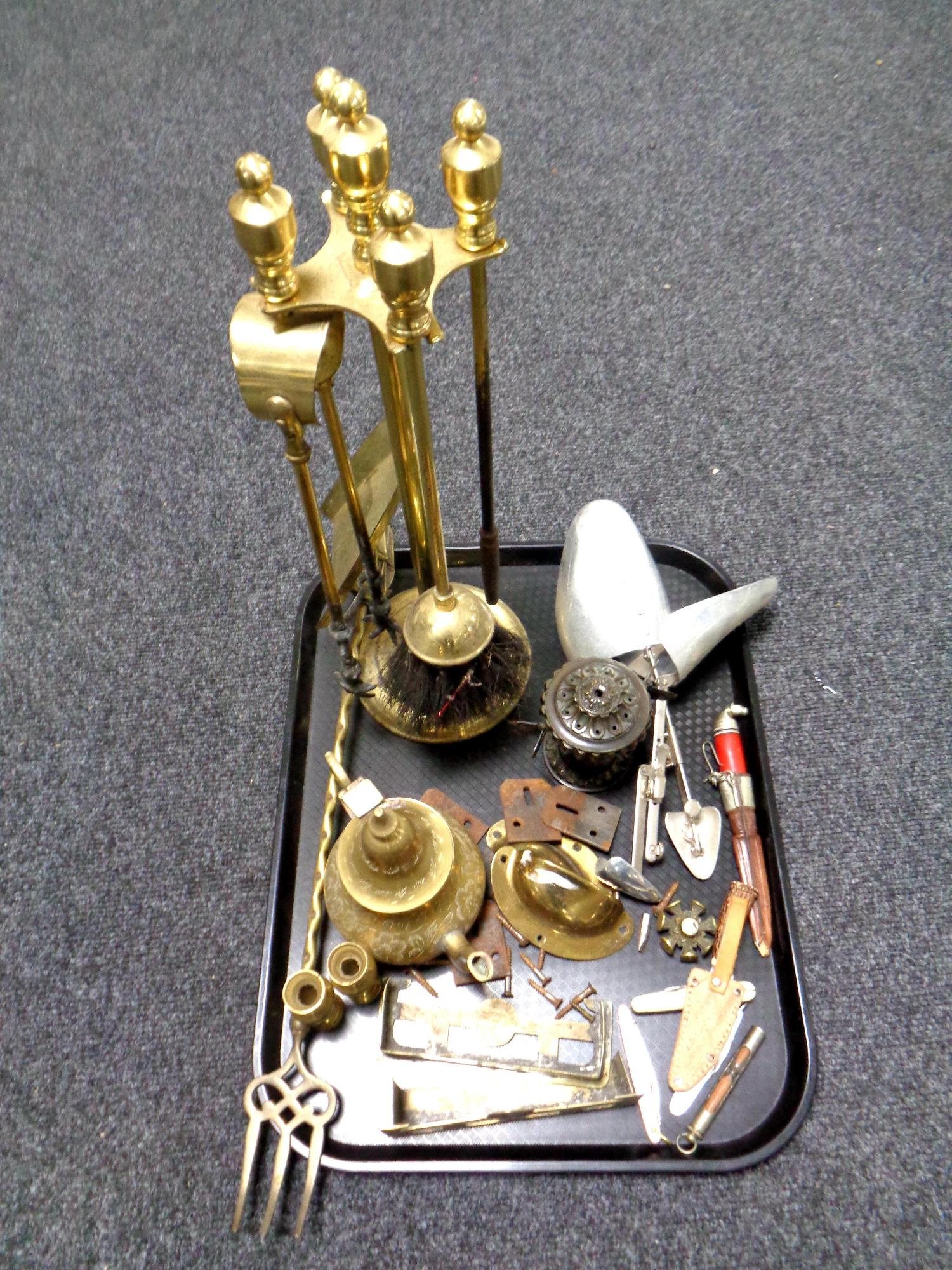 A tray containing antique and later metal wares to include shoe stretchers, companion set on stand,