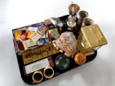 A tray containing miscellaneous to include match books, anniversary clock, plated trophies,