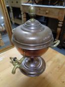 A 19th century copper and brass tea urn