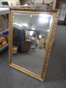 A gilt framed bevel edged overmantel mirror