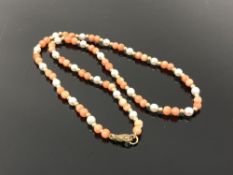 A coral and pearl necklace with gold beads and gold clasp