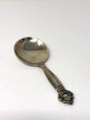 A Georg Jensen silver acorn pattern caddy spoon