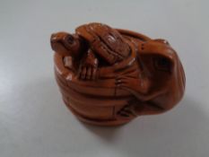 A carved Chinese hardwood netsuke,