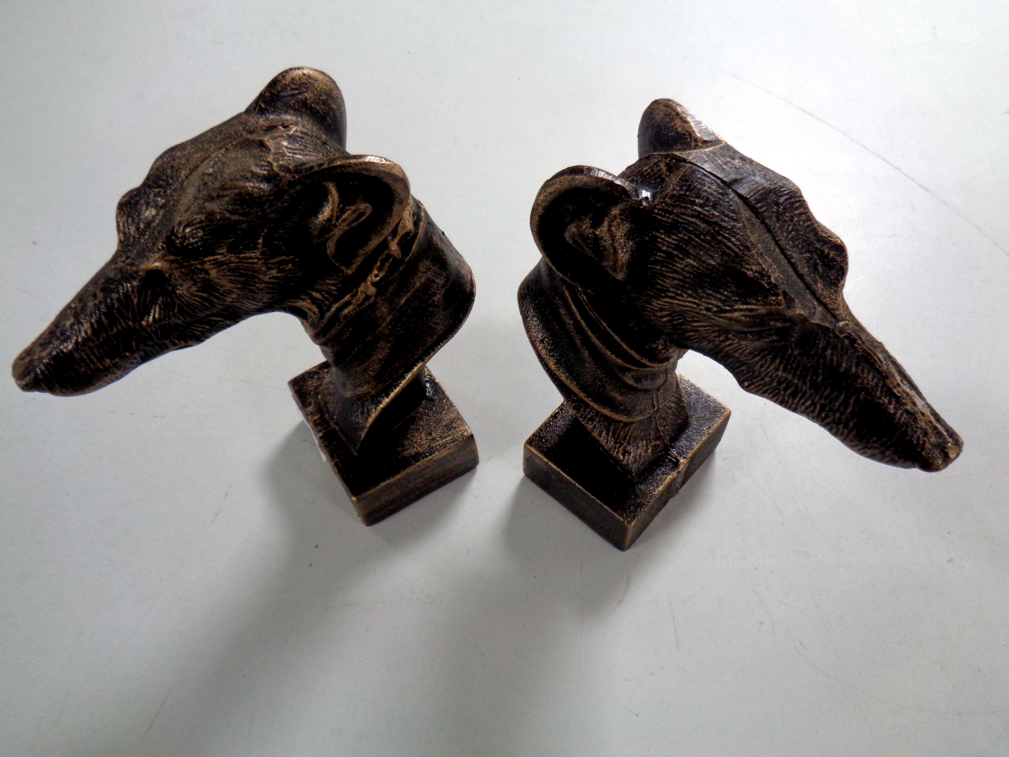 A pair of cast iron greyhound head book ends