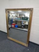 A large gilt framed overmantel mirror