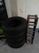 A set of four 195/70 R14 snow tyres together with a pair of metal car ramps