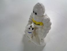 A cast iron figure - Michelin man with dog