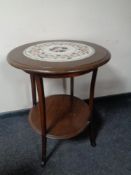 An Edwardian circular two tier occasional table with an inset marble panel