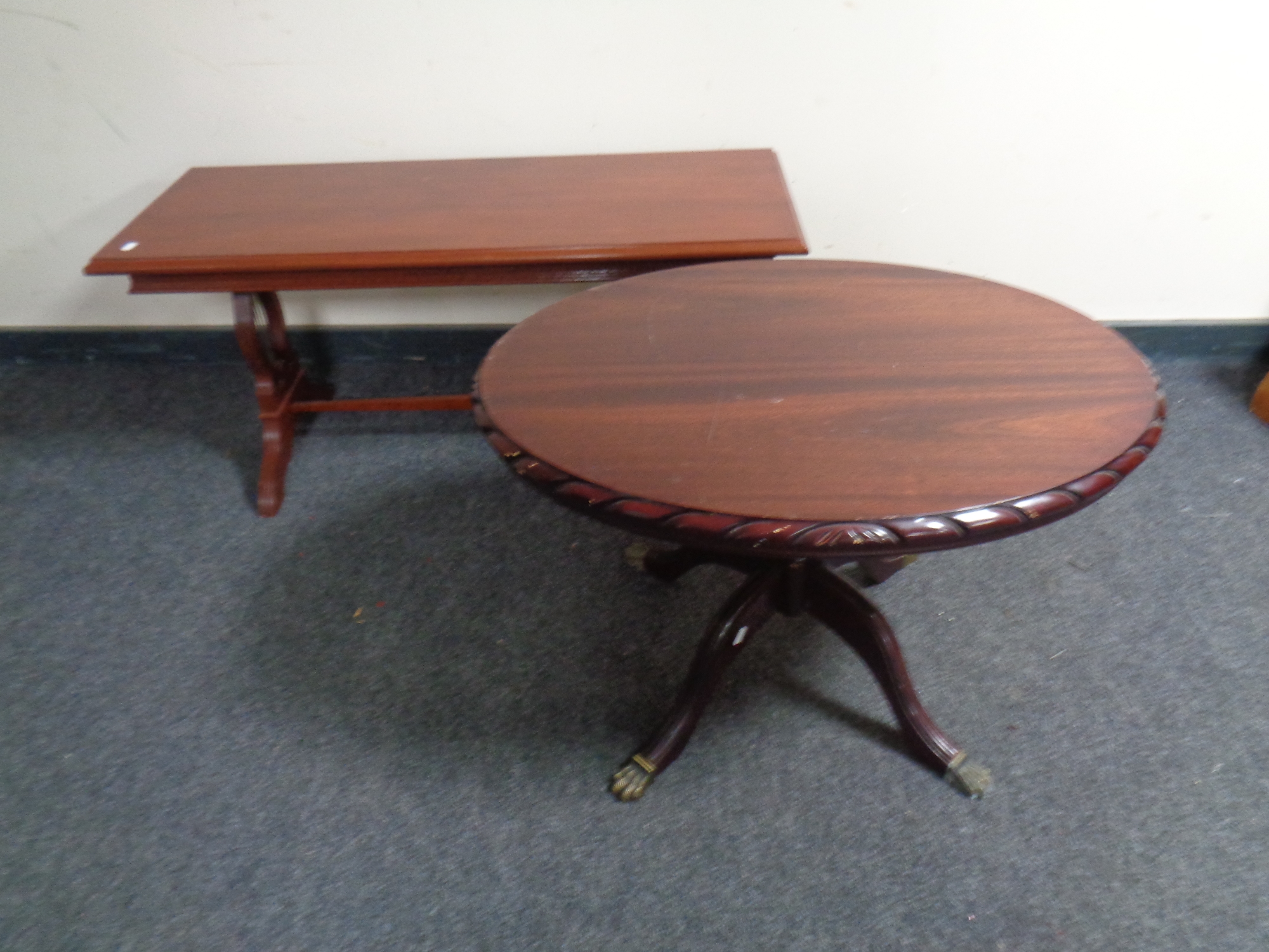 An oval mahogany pedestal coffee table together with a further coffee table