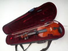 A 1/4 size violin and bow in case