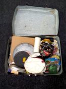 A twentieth century luggage case containing film reels, splicer, toys,