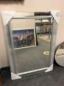 An all glass mirror with silvered frame,